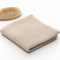 Waffle bathroom towel set styled in a warm minimalist bathroom with folded towels, bath accessories, and calm home details.