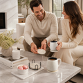 Couple enjoying coffee in a premium calm living room with marble-style ceramic coasters on the table
