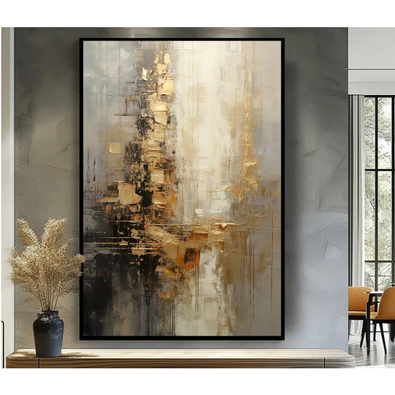 Textured abstract canvas wall art in gold, beige, grey and black, hand painted acrylic, black frame, displayed on grey wall with decorative vase
