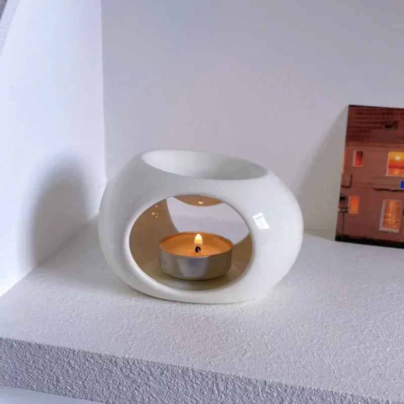 Minimalist ceramic candle holder — warm glowing tea light, cozy home atmosphere
