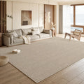 Premium neutral area rug covering a spacious designer living room floor with soft beige texture and warm natural light