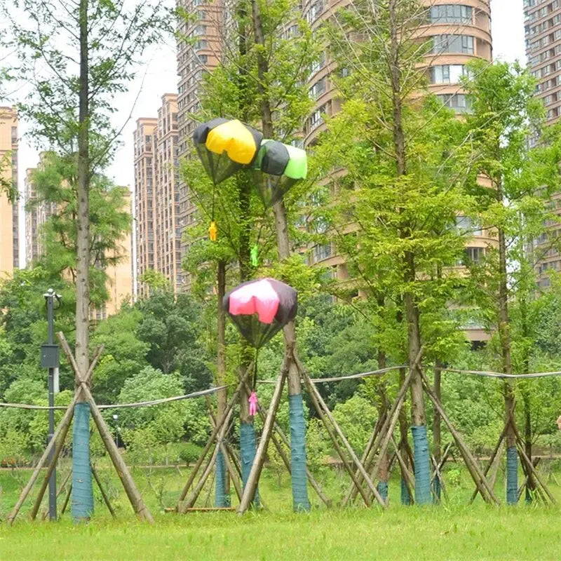 Kids playing with flying parachute toys outdoors during active play