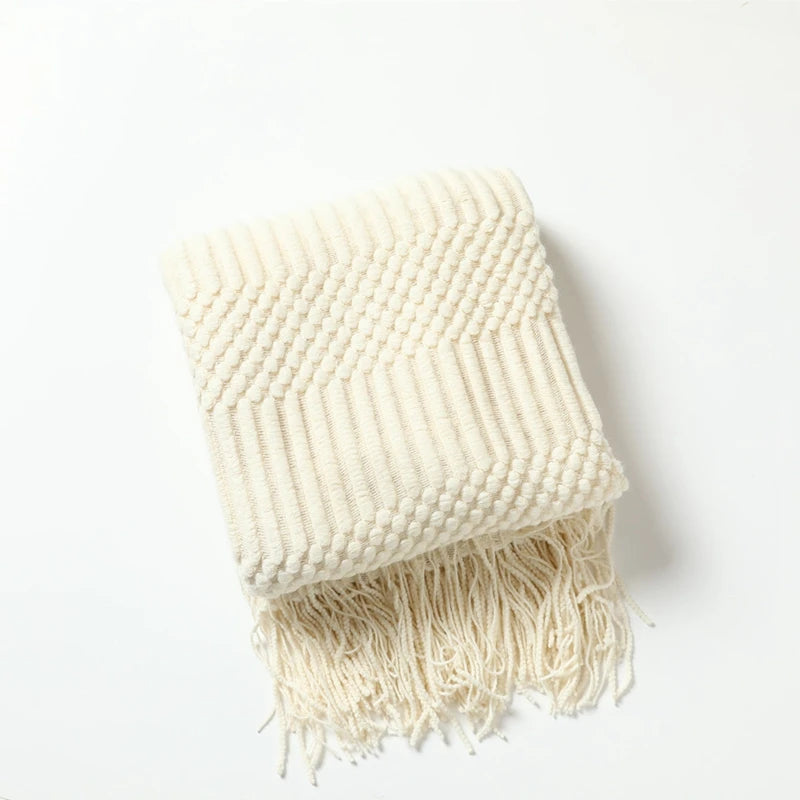 Cozy decorative knit throw blanket arranged in a reading corner, made for quiet moments, rest, and family connection.