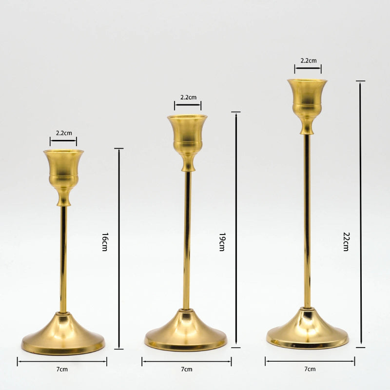 Elegant gold metal candle stands set of 3 on styled sideboard with neutral home decor accents