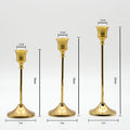 Elegant gold metal candle stands set of 3 on styled sideboard with neutral home decor accents
