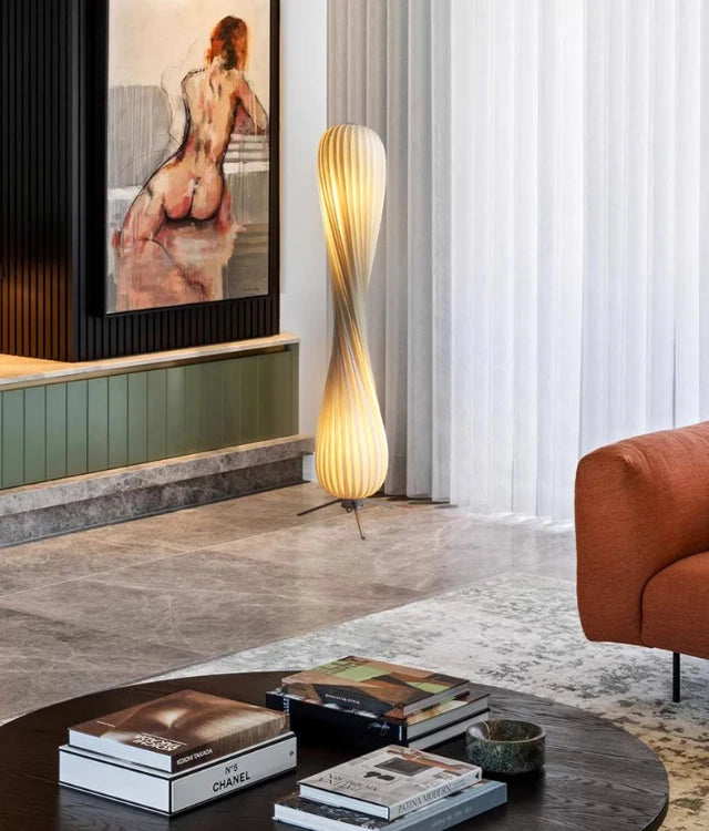 Sculptural wooden floor lamp styled in a calm premium family living room with Usfera decor accents