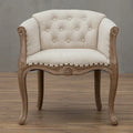 Premium upholstered accent chair with solid wood frame, curved arms, button-tufted back, and refined French-style design