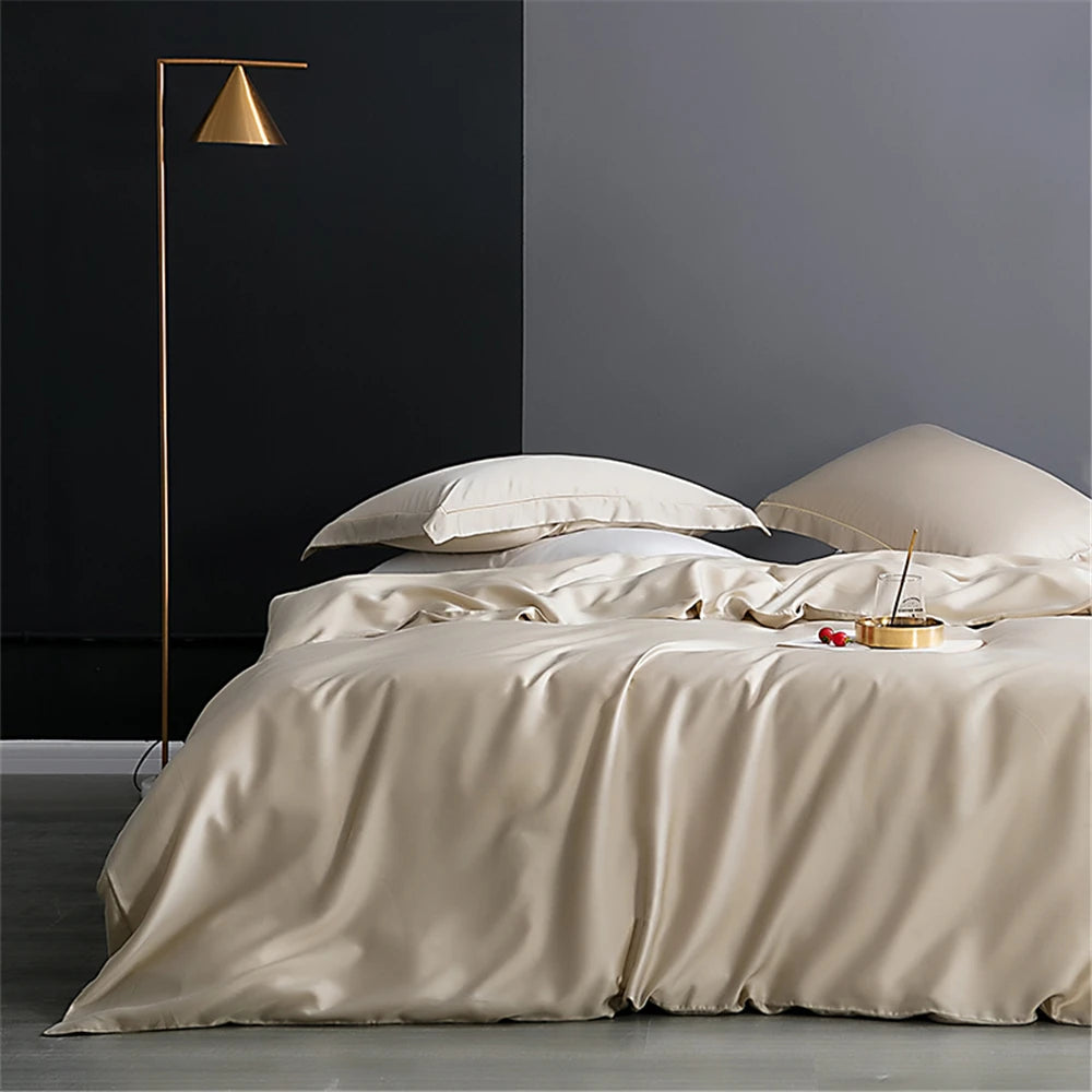 Premium champagne silk bed linen draped across a modern bed in a calm luxury bedroom interior