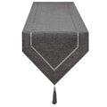 Elegant table runner in dark gray linen, styled dining table with neutral ceramic plates and soft candlelight