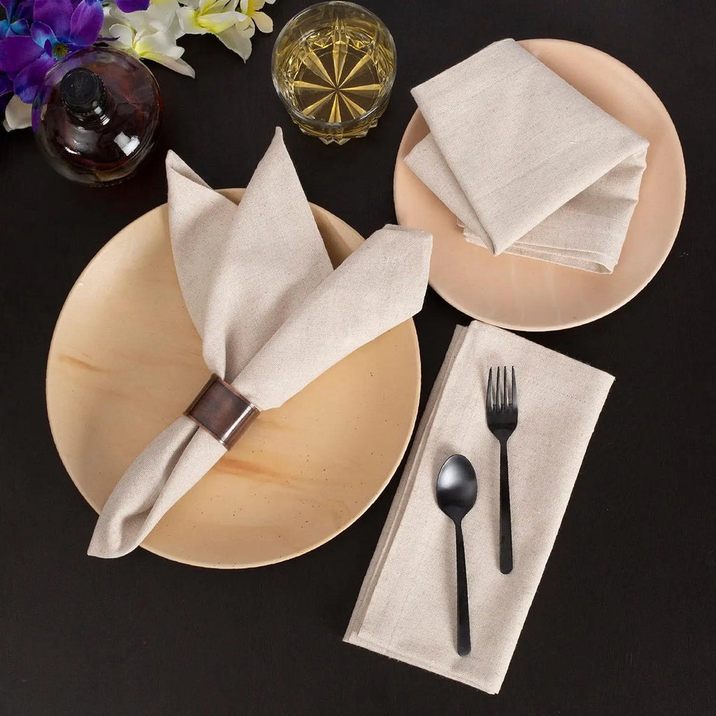 Reusable cotton linen napkins in a premium neutral table setting with plates and cutlery
