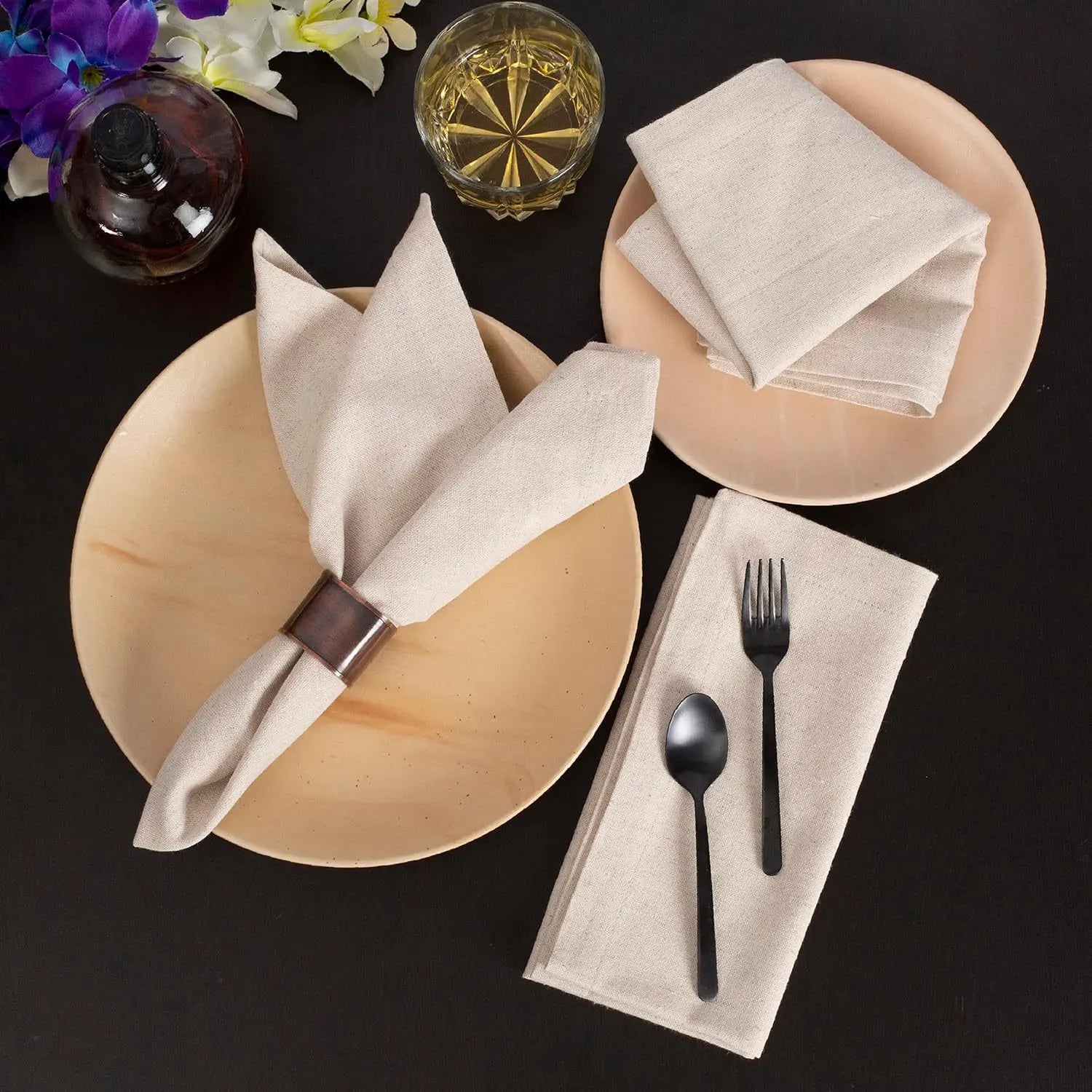 Reusable cotton linen napkins in a premium neutral table setting with plates and cutlery