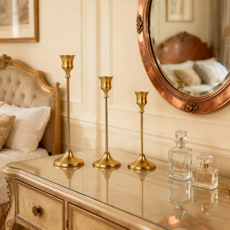 Close-up of gold metal candlestick holder with classic European silhouette, warm gold finish detail
