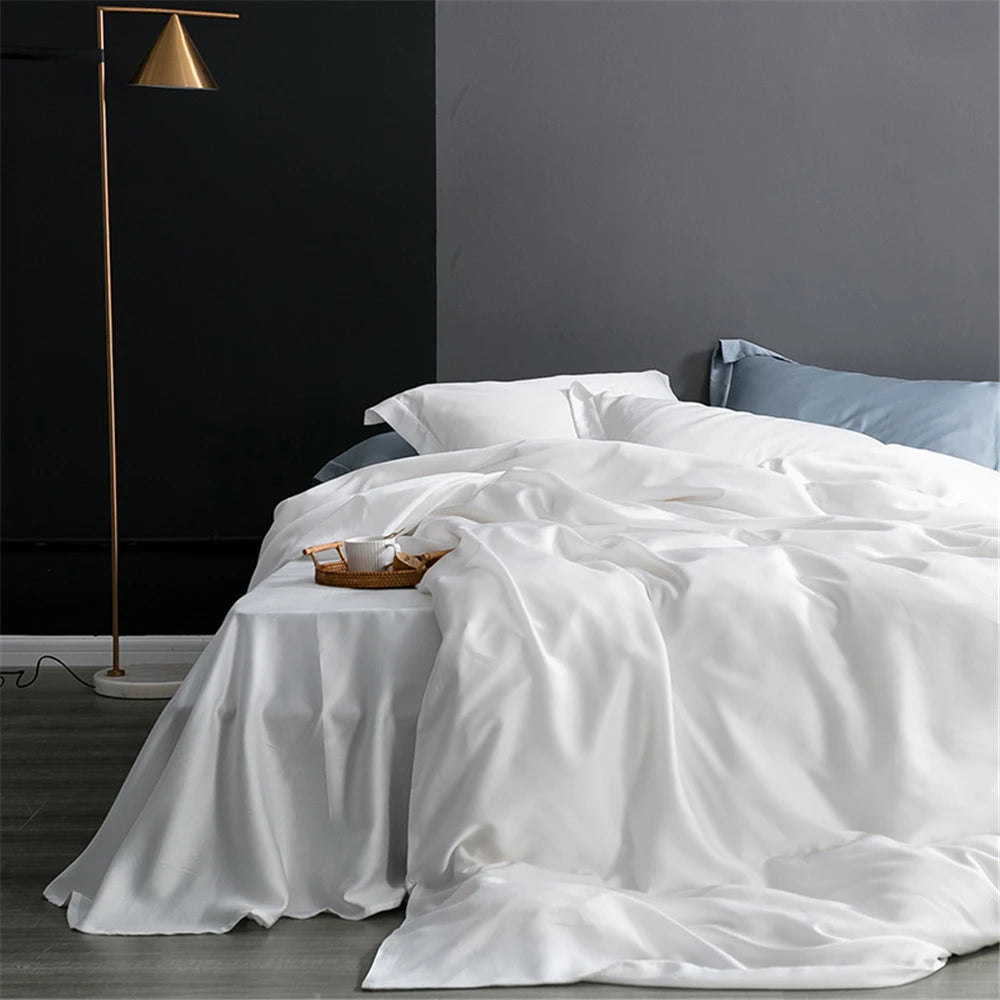 Ultra-premium silk bedding set with smooth ivory-champagne finish styled for a sophisticated quiet luxury bedroom