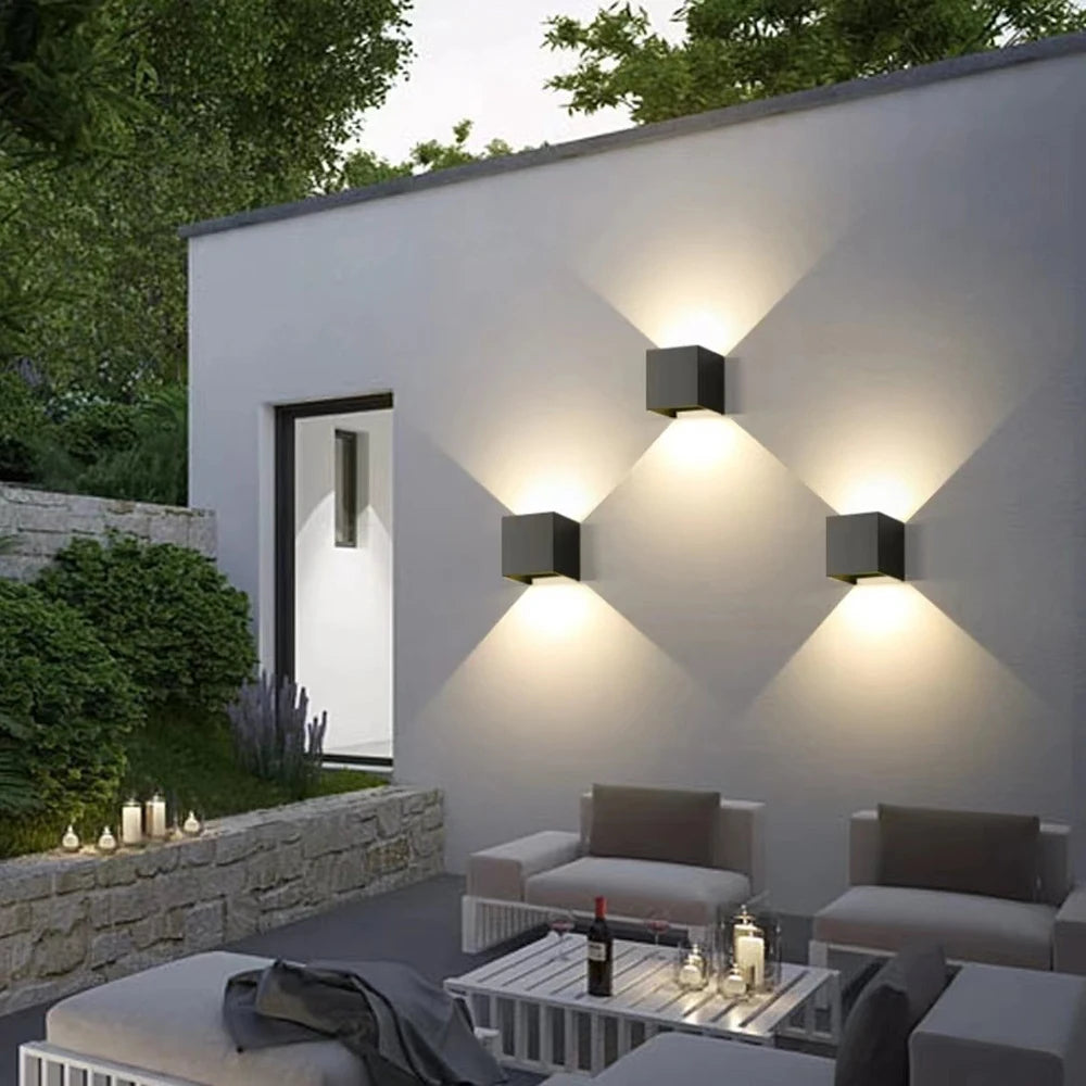 Modern outdoor wall light with warm white glow on exterior patio wall for calm evening outdoor living