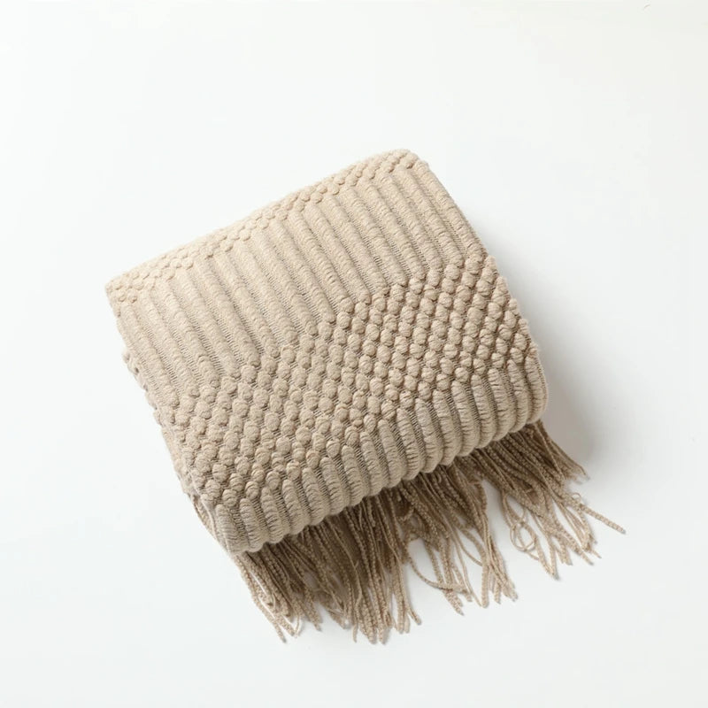 Cream and beige knitted throw blanket styled for bedroom and living room comfort, supporting a softer calm home atmosphere.