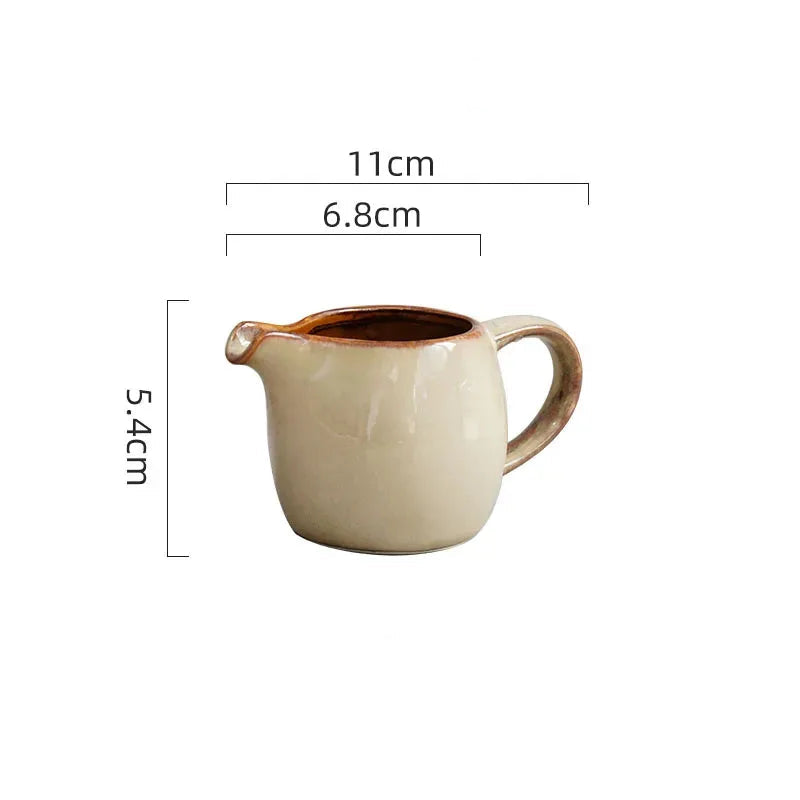 Cream ceramic creamer pitcher pouring sauce over fries for calm luxury dining and family table styling