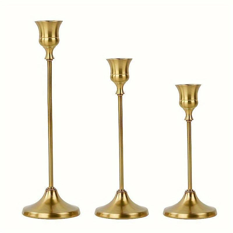 Gold candlestick holders set centerpiece on wooden dining table, family dinner setting with soft candlelight