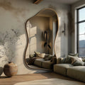 Luxury irregular full body wall mirror with sculptural frame in a premium sunlit living room