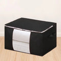 Large black fabric storage bag filled with folded bedding and knit blankets, designed for calm home organization and bedroom storage.
