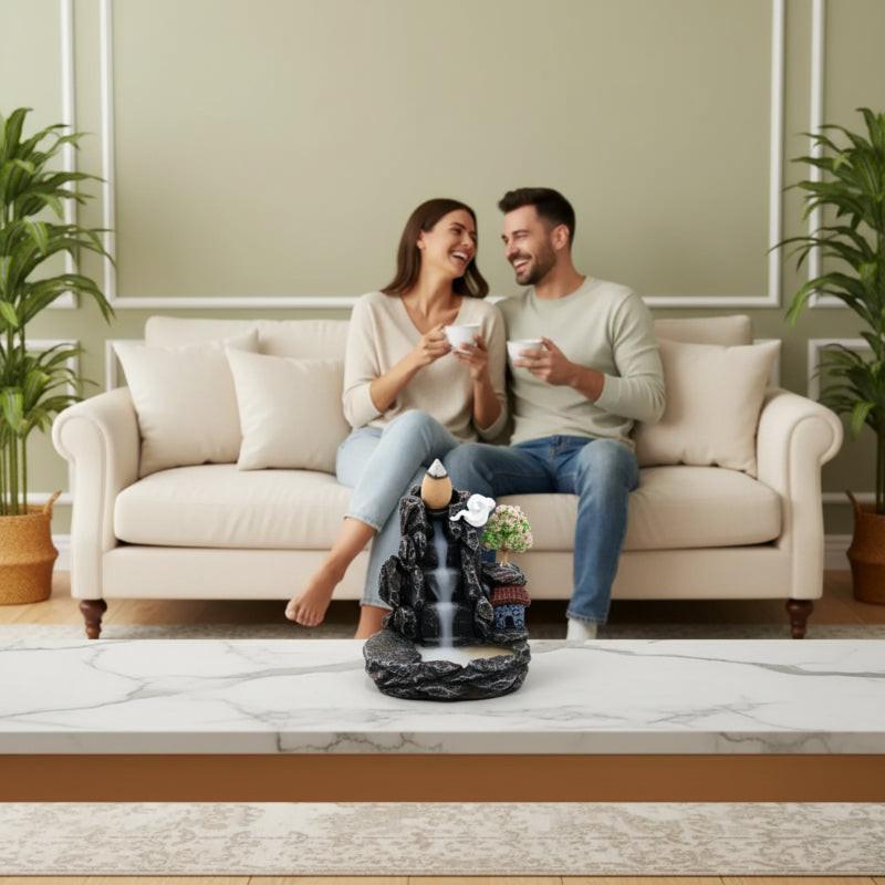 Couple relaxing in luxury living room with zen mountain incense burner on marble shelf — Usfera
